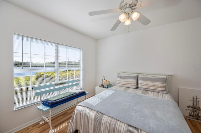 bedroom with hardwood / wood-style flooring and ceiling fan