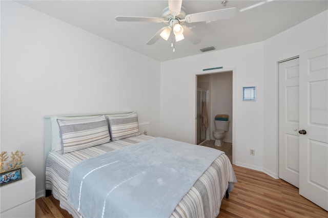 bedroom featuring connected bathroom, ceiling fan, a closet, and light hardwood / wood-style floors