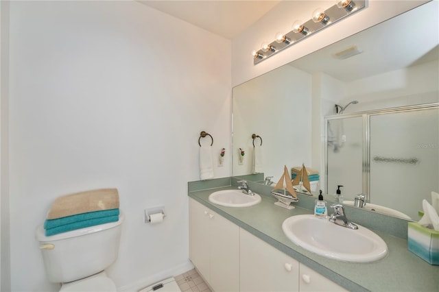 bathroom featuring vanity, toilet, and an enclosed shower