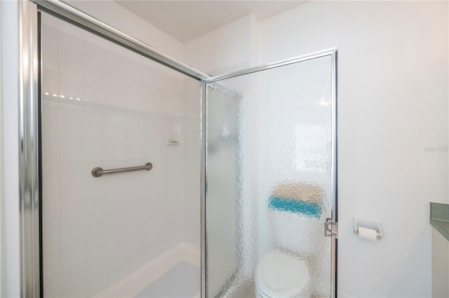 bathroom featuring a shower with door