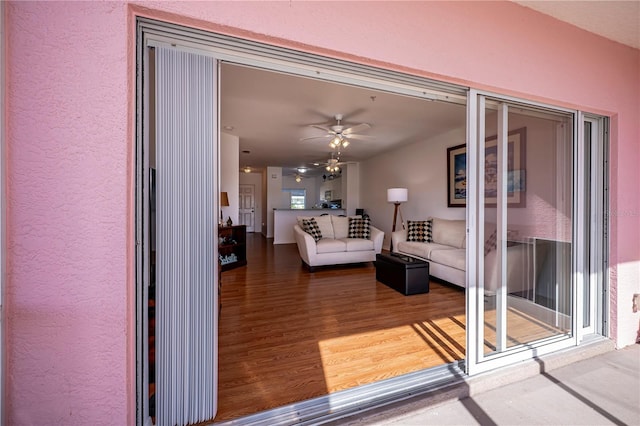 living room with hardwood / wood-style flooring and ceiling fan