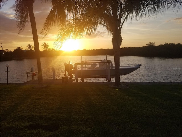 dock area featuring a yard and a water view