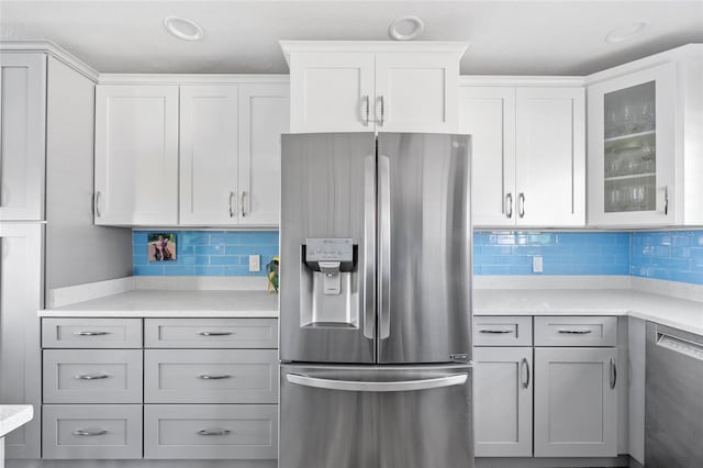 kitchen featuring backsplash, gray cabinets, white cabinetry, and stainless steel appliances