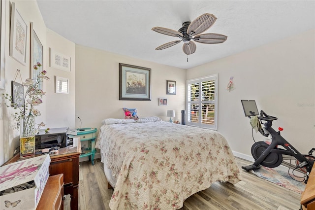 bedroom featuring wood-type flooring and ceiling fan