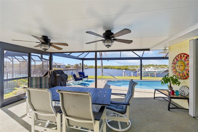 exterior space with a water view and ceiling fan