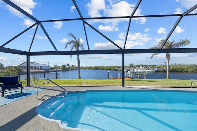 view of swimming pool with glass enclosure, a patio area, and a water view