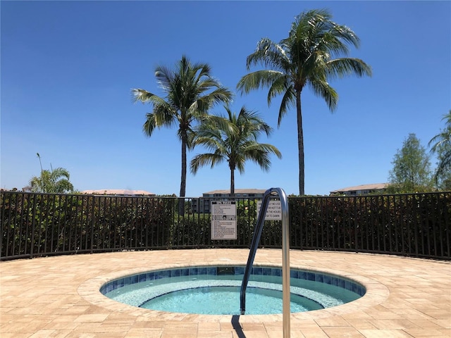 view of swimming pool with a community hot tub