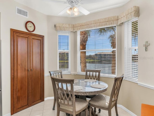 dining space featuring light tile patterned floors and ceiling fan