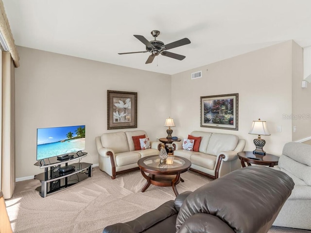 carpeted living room featuring ceiling fan