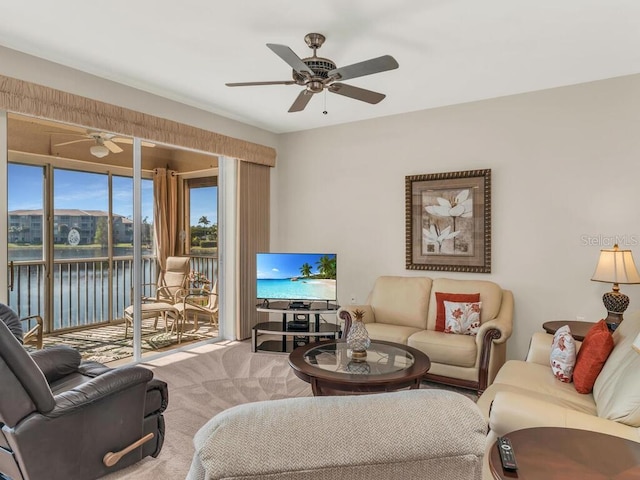 carpeted living room with ceiling fan