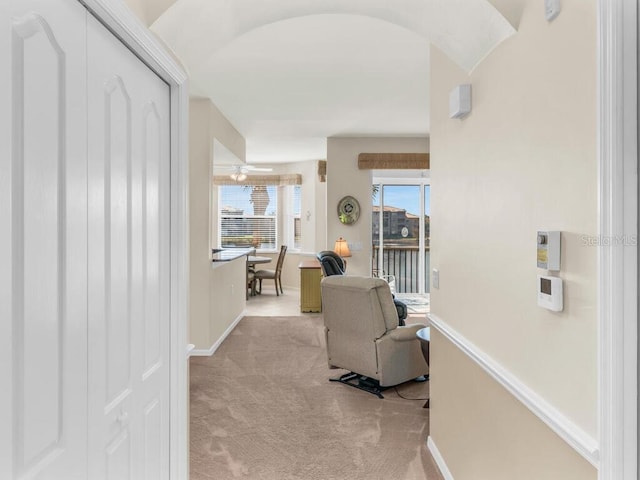 hallway featuring light colored carpet