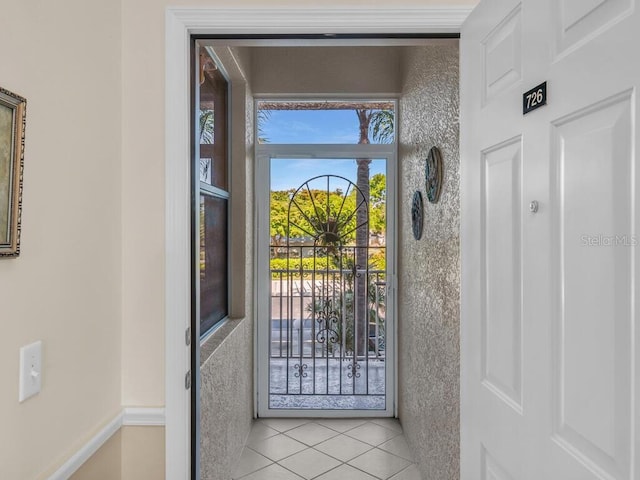 entryway with light tile patterned floors