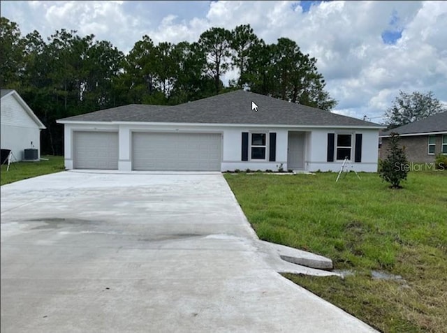 view of front facade with a front yard, central AC, and a garage