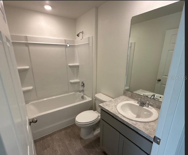 full bathroom featuring toilet, vanity, shower / bathtub combination, and hardwood / wood-style flooring