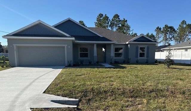 view of front of home featuring a garage and a front lawn