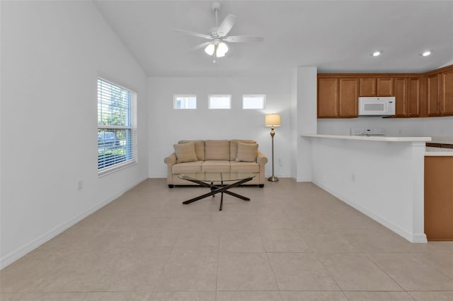 living room with ceiling fan, light tile patterned floors, and vaulted ceiling