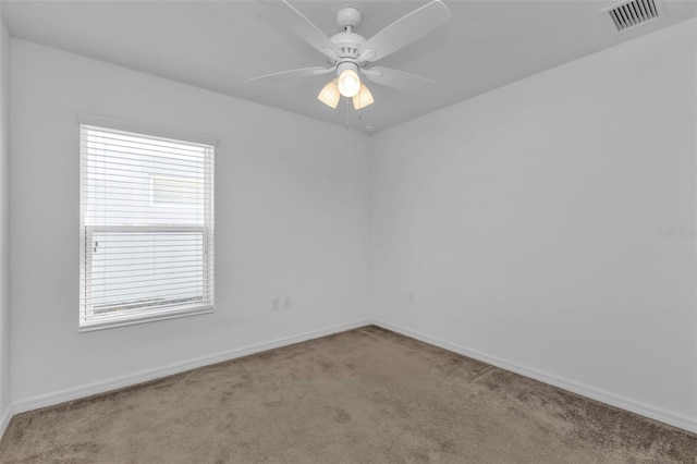 unfurnished room with light colored carpet and ceiling fan