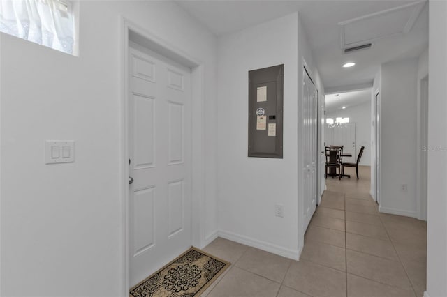 hall with electric panel and light tile patterned floors