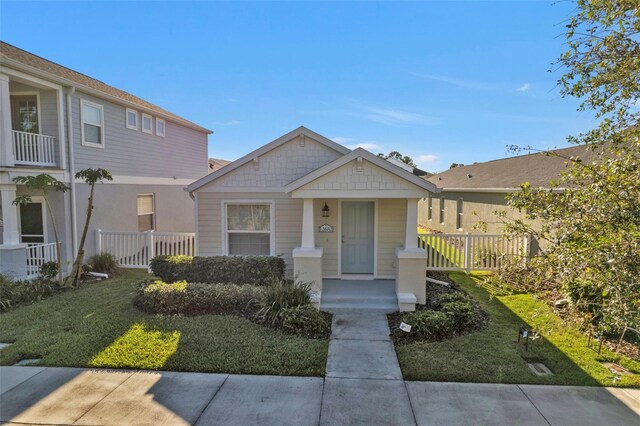 view of front of property with a front yard and a porch