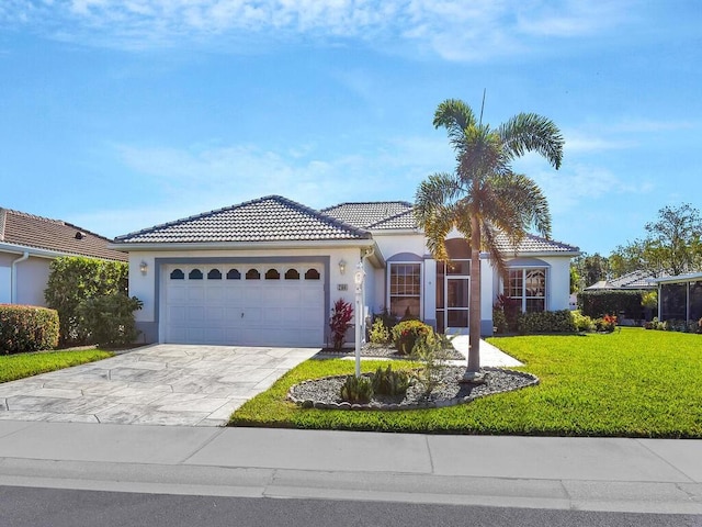 mediterranean / spanish house with a front yard and a garage