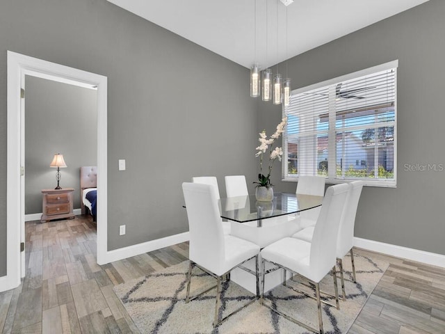 dining room with a notable chandelier and wood-type flooring