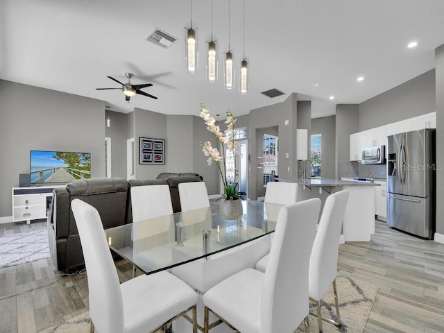 dining area featuring ceiling fan and light hardwood / wood-style floors