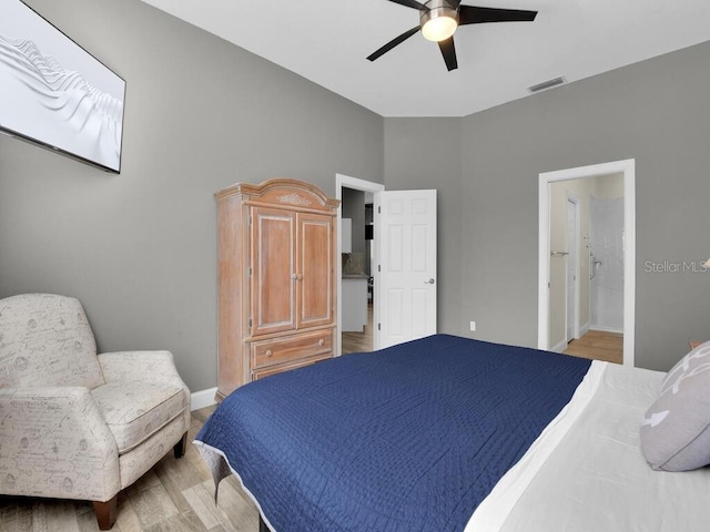 bedroom with ceiling fan, ensuite bathroom, and wood-type flooring