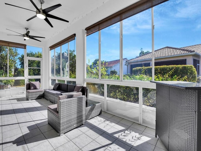 sunroom featuring ceiling fan