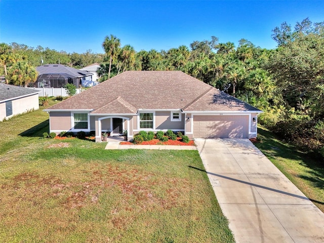 view of front of house featuring a front lawn and a garage