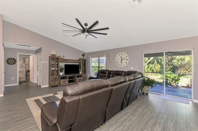 living room with ceiling fan, hardwood / wood-style floors, and vaulted ceiling