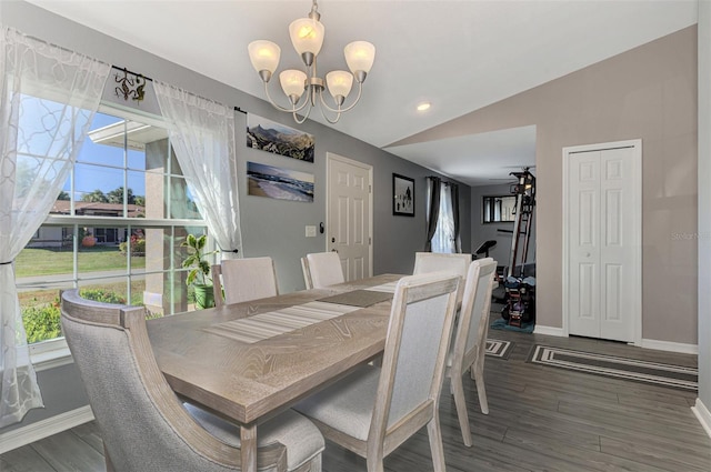 dining space with ceiling fan with notable chandelier, dark hardwood / wood-style flooring, and lofted ceiling