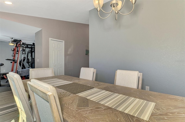 dining area with an inviting chandelier