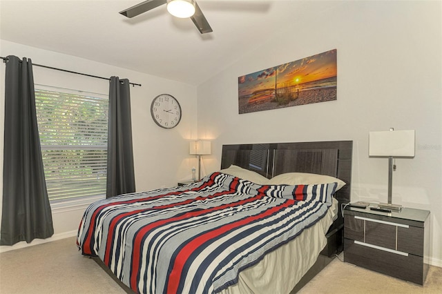 carpeted bedroom with ceiling fan and vaulted ceiling