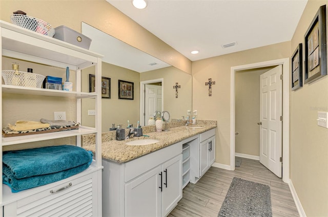 bathroom with vanity and wood-type flooring