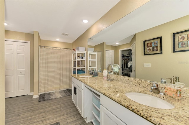 bathroom featuring a shower with shower curtain, wood-type flooring, and vanity