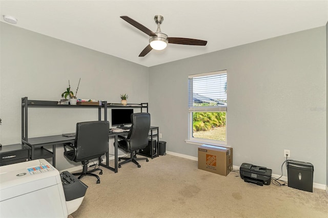 carpeted home office featuring ceiling fan