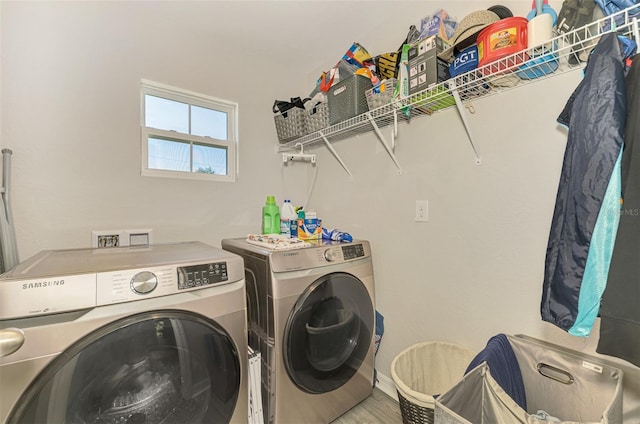 clothes washing area with independent washer and dryer