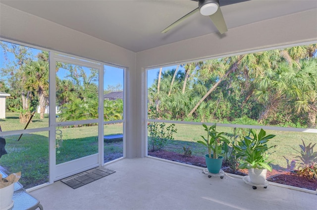 unfurnished sunroom with ceiling fan