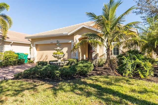 mediterranean / spanish-style house with a front yard and a garage