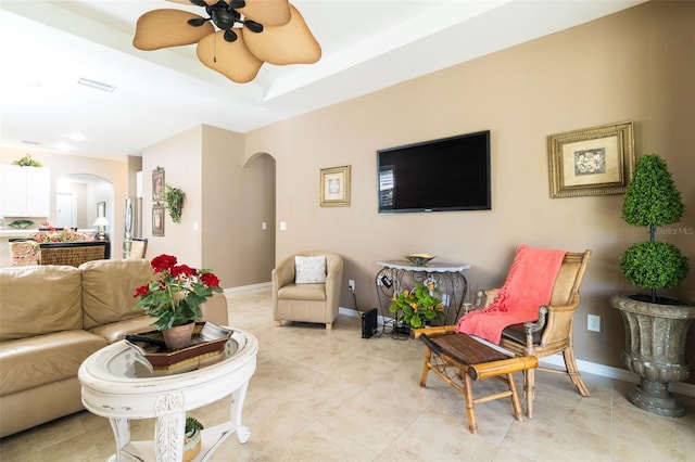 tiled living room featuring ceiling fan