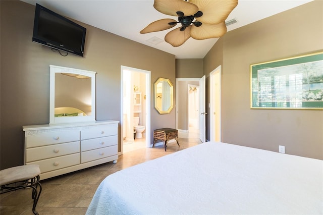 bedroom with tile patterned floors, ceiling fan, and ensuite bath