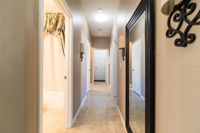 hallway with light tile patterned floors