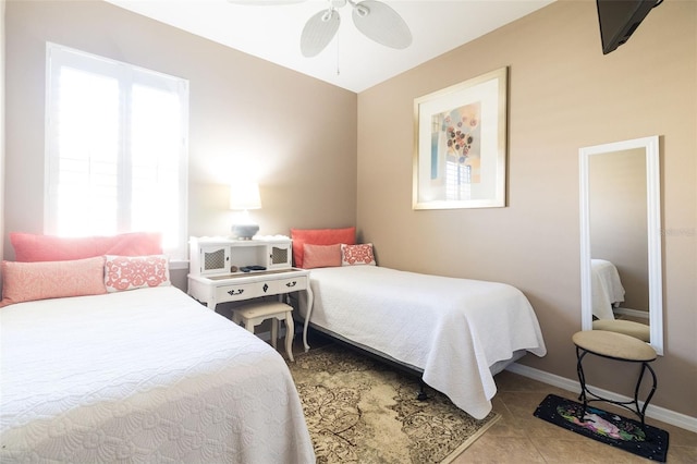 tiled bedroom with ceiling fan and multiple windows