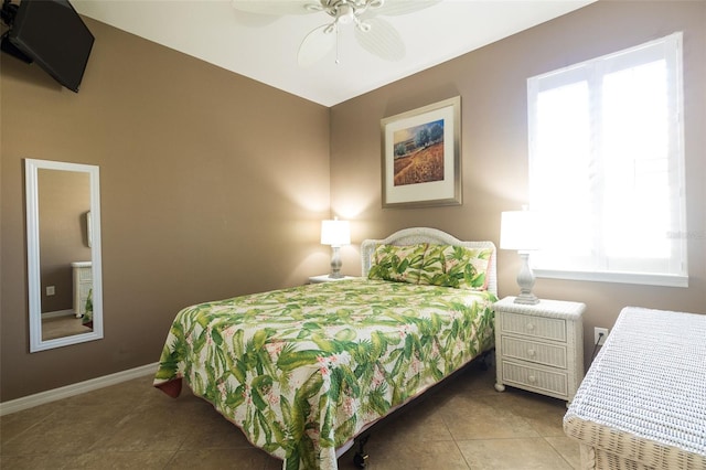 tiled bedroom featuring ceiling fan