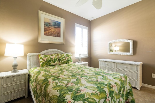 tiled bedroom featuring ceiling fan