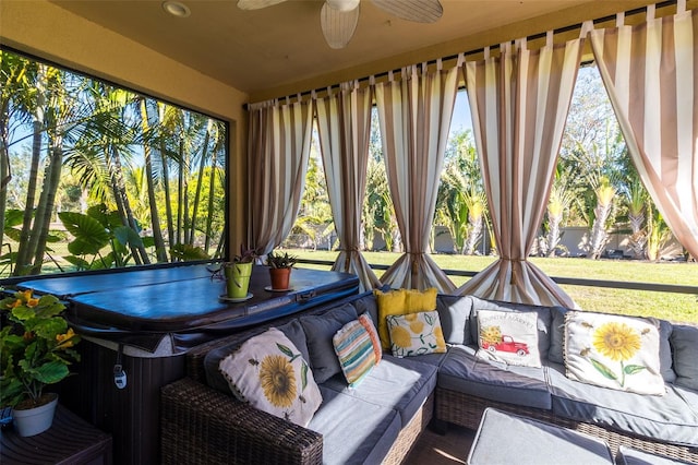 sunroom / solarium with a hot tub, ceiling fan, and a healthy amount of sunlight