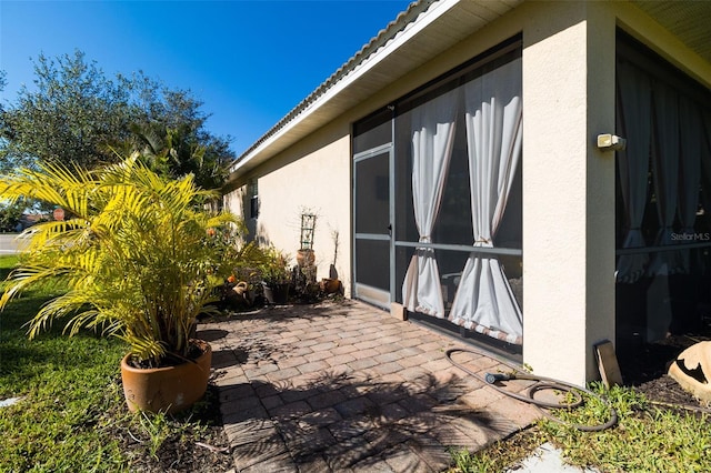 view of side of home with a patio