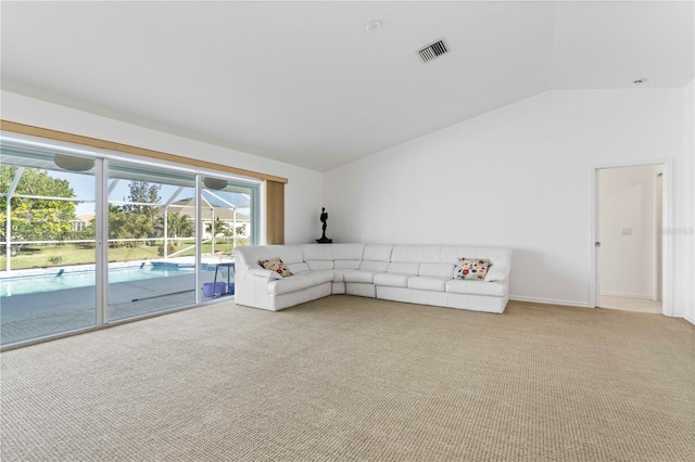 unfurnished living room featuring light colored carpet and vaulted ceiling