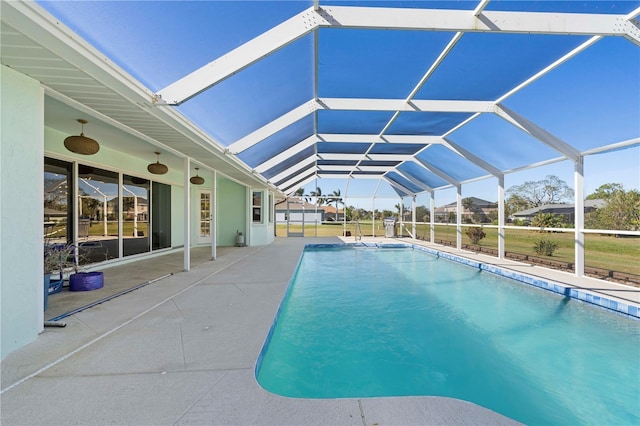 view of swimming pool with a lanai and a patio area