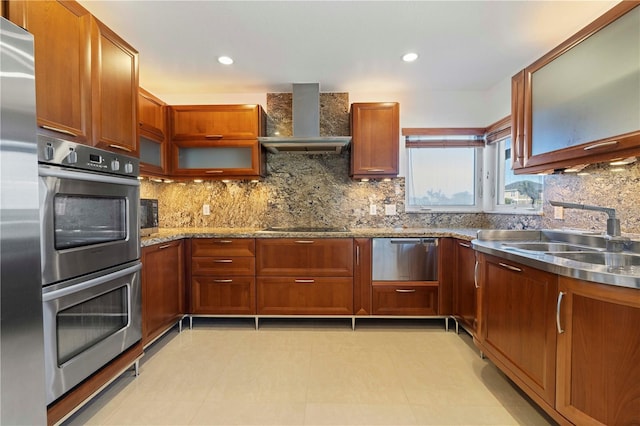 kitchen with wall chimney exhaust hood, decorative backsplash, and sink